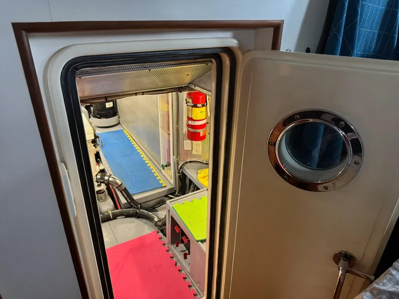 Slide: The Image of Engine room of 2003 Nordhavn N46 yacht with open door and visible equipment. - 32