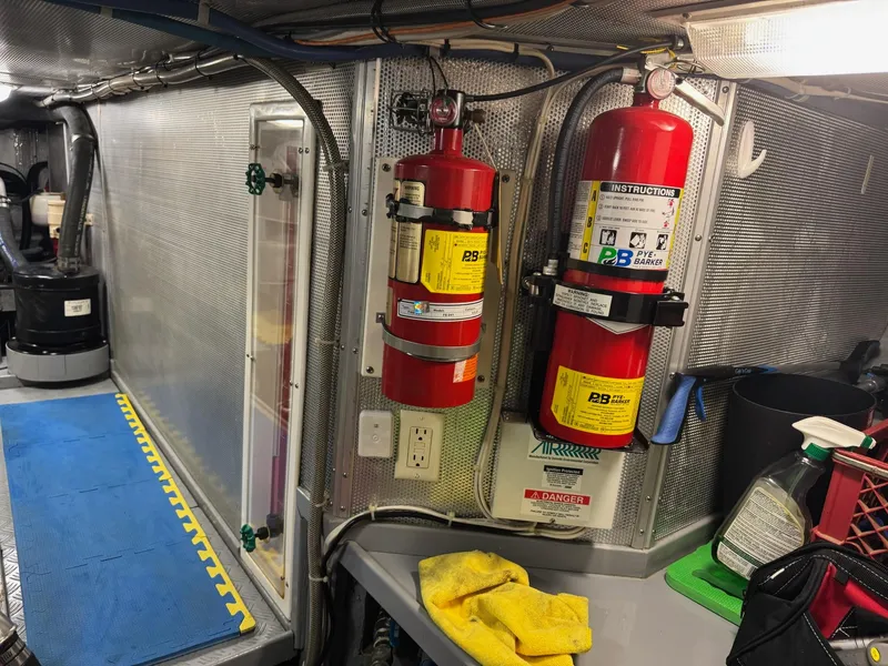 Slide: The Image of Engine room of 2003 Nordhavn N46 yacht with fire extinguishers and maintenance tools. - 37