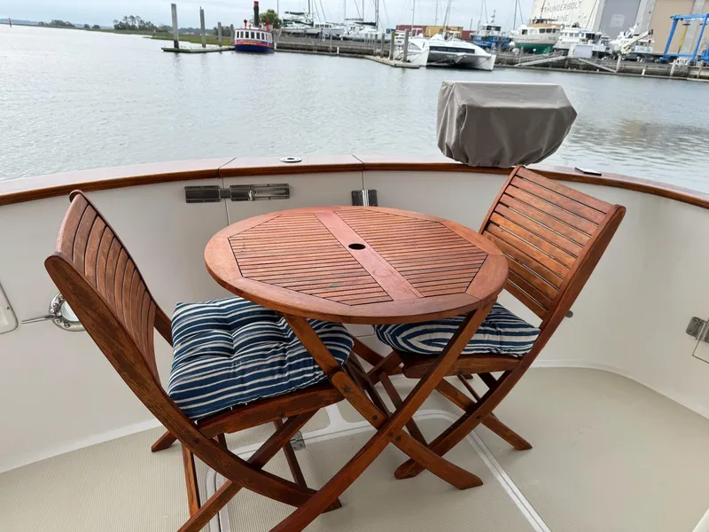 Slide: The Image of Wooden deck furniture on 2003 Nordhavn N46 yacht, overlooking marina. - 4