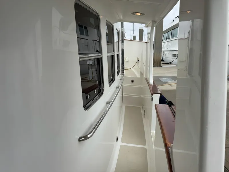 Slide: The Image of Side deck of 2003 Nordhavn N46 yacht, featuring sleek design and polished handrails. - 5
