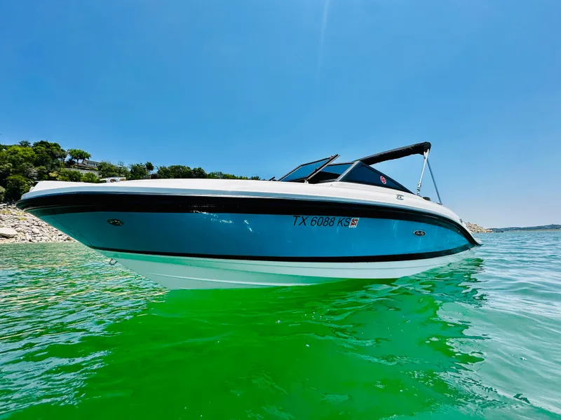 Slide: The Image of 2022 Sea Ray SPX 210 boat on clear green water under blue sky. - 1
