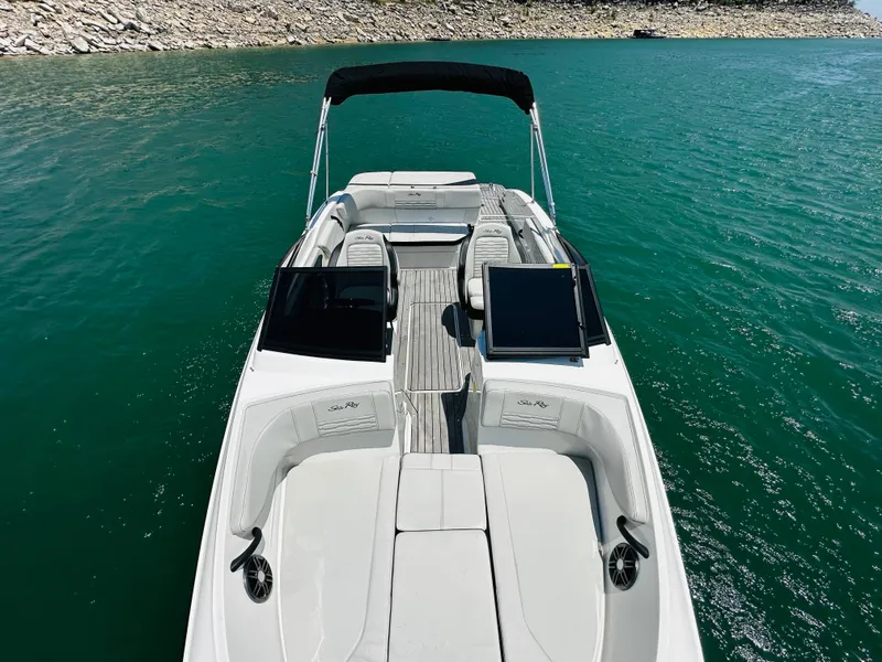 Slide: The Image of 2022 Sea Ray SPX 210 boat on clear blue water, featuring sleek design and spacious seating. - 20