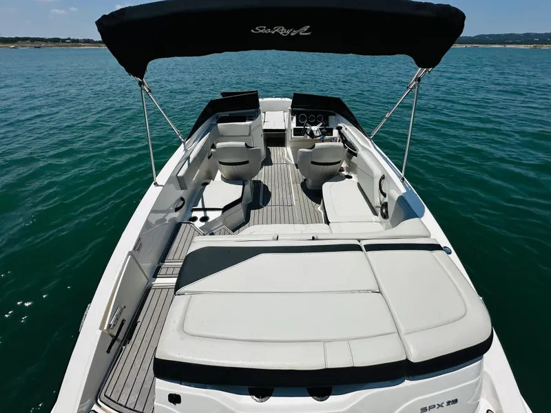 Slide: The Image of 2022 Sea Ray SPX 210 boat with canopy on open water. - 21