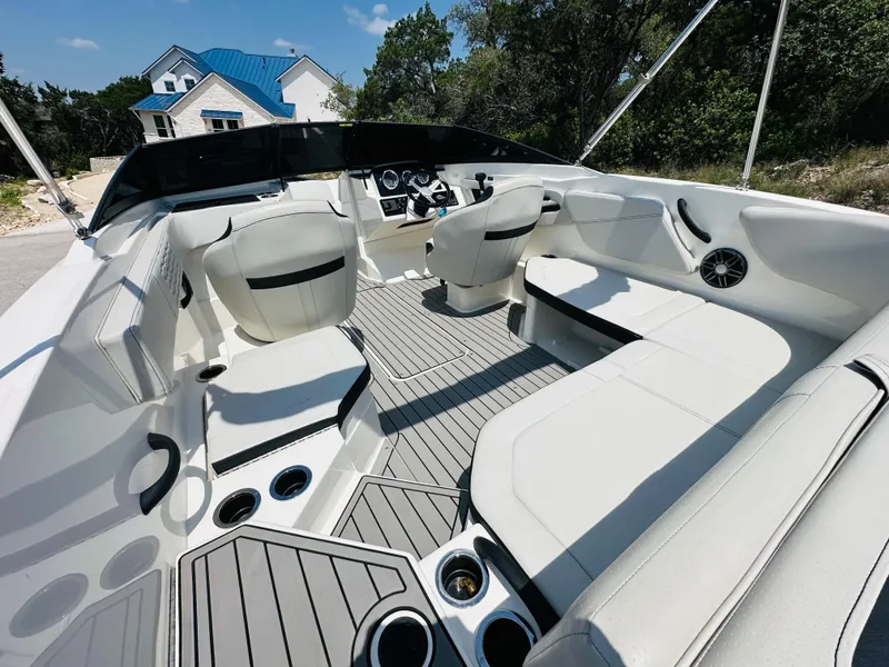 Slide: The Image of 2022 Sea Ray SPX 210 boat interior with white seating and modern dashboard. - 22