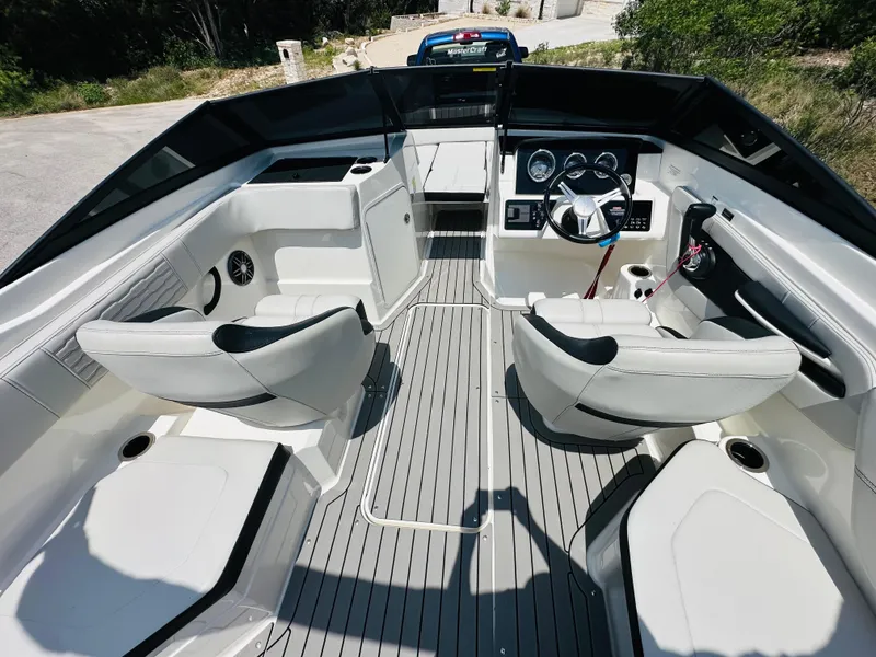 Slide: The Image of 2022 Sea Ray SPX 210 boat interior with modern seating and sleek dashboard design. - 24