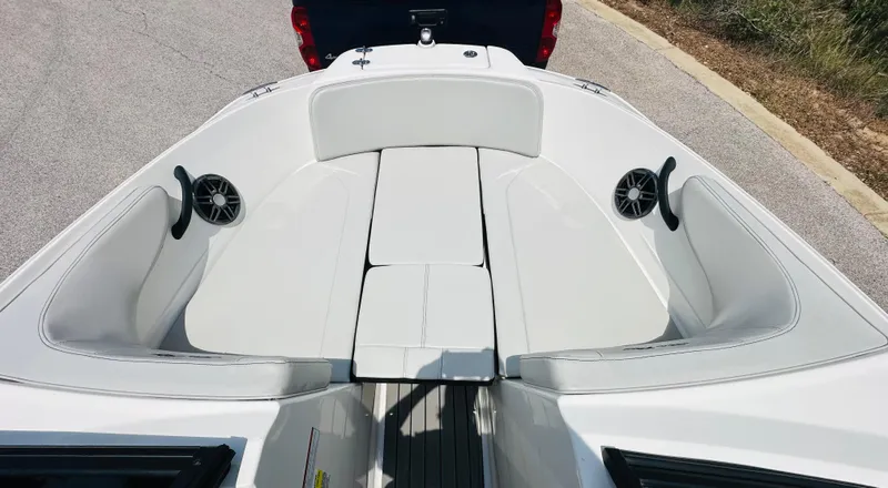 Slide: The Image of 2022 Sea Ray SPX 210 boat interior with white seating and speakers. - 27