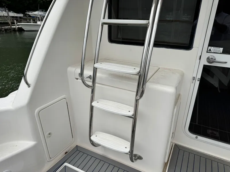 Slide: The Image of Stainless steel ladder on 2005 Riviera 33 Flybridge yacht, leading to upper deck. - 10