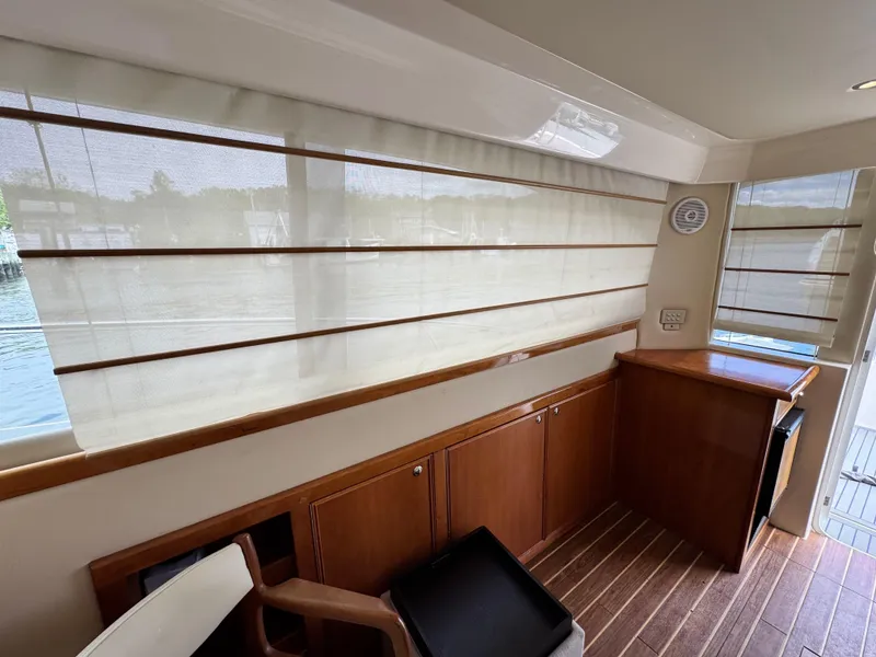 Slide: The Image of Interior of 2005 Riviera 33 Flybridge yacht with wooden cabinetry and large windows. - 15