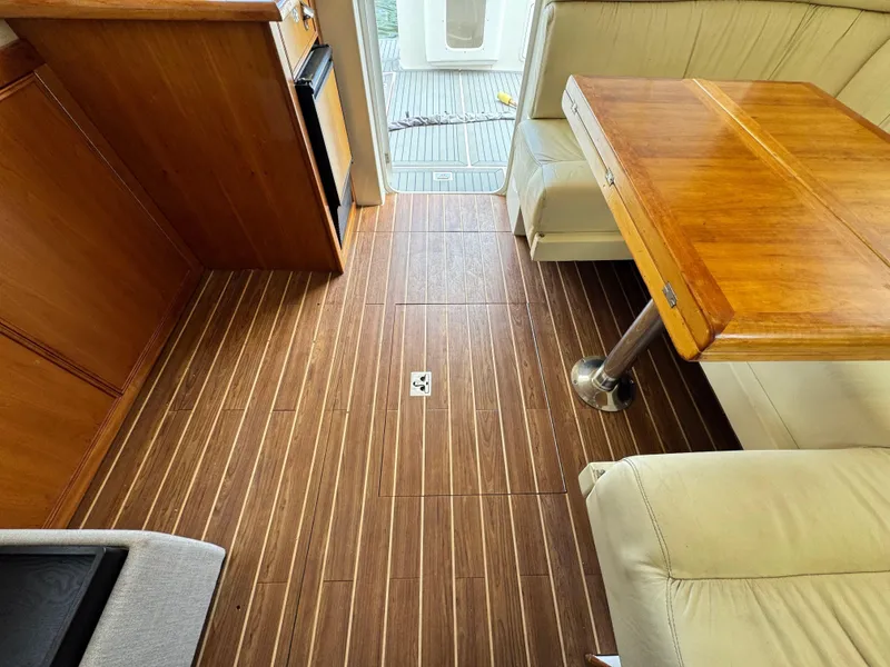 Slide: The Image of Interior of 2005 Riviera 33 Flybridge with wooden flooring and dining area. - 17