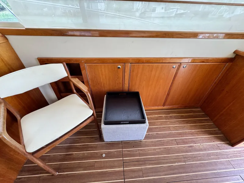Slide: The Image of Interior of 2005 Riviera 33 Flybridge with wooden cabinets and chair. - 20