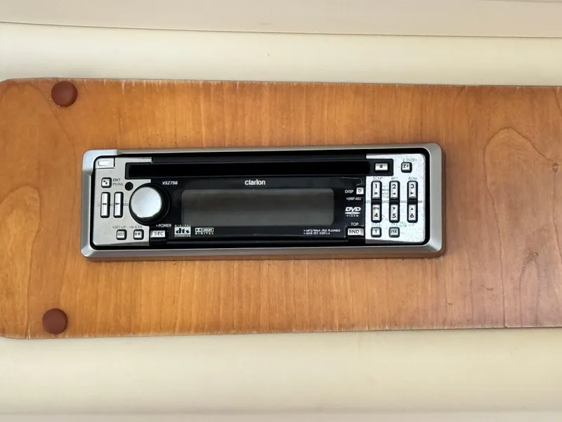 Slide: The Image of Clarion stereo system on 2005 Riviera 33 Flybridge boat, mounted on wooden panel. - 25