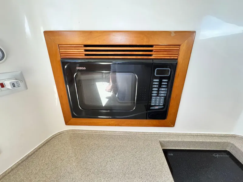 Slide: The Image of Built-in microwave in 2005 Riviera 33 Flybridge yacht kitchen. - 31