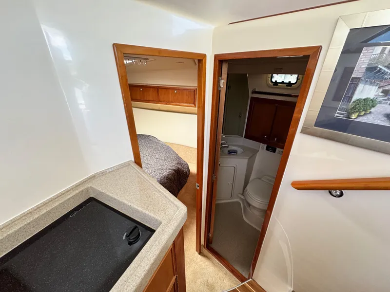 Slide: The Image of Interior of 2005 Riviera 33 Flybridge yacht with bedroom and bathroom. - 33