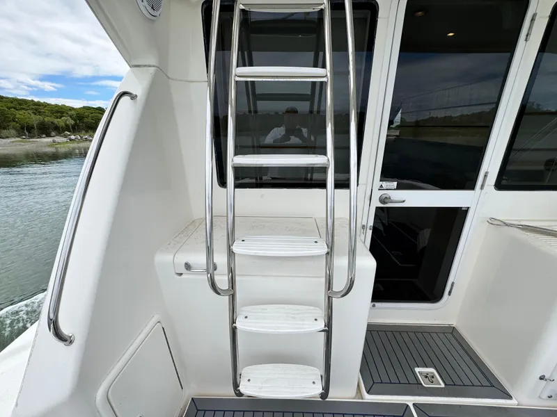 Slide: The Image of Stainless steel ladder on 2005 Riviera 33 Flybridge yacht deck. - 38