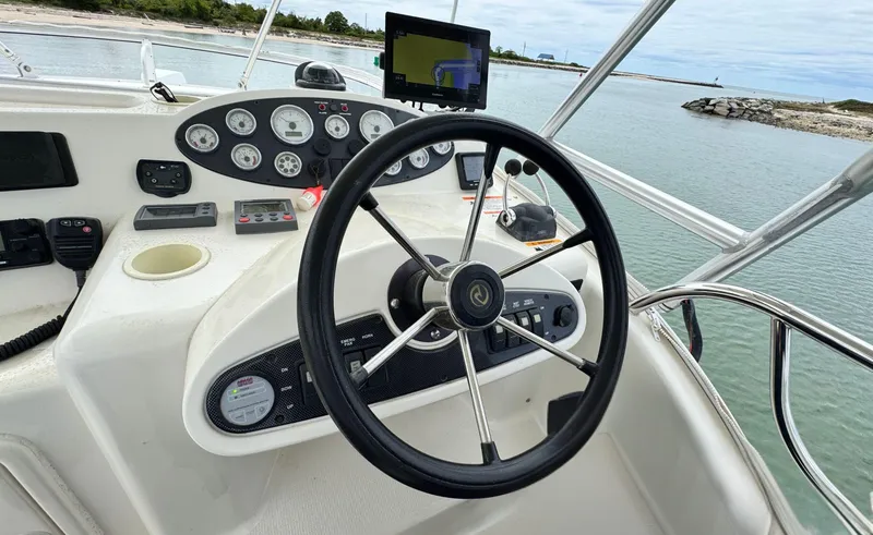 Slide: The Image of 2005 Riviera 33 Flybridge helm with steering wheel and navigation instruments. - 40