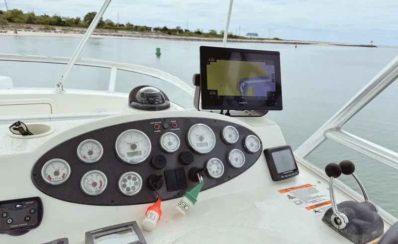 Slide: The Image of Control panel of a 2005 Riviera 33 Flybridge boat with navigation instruments. - 43