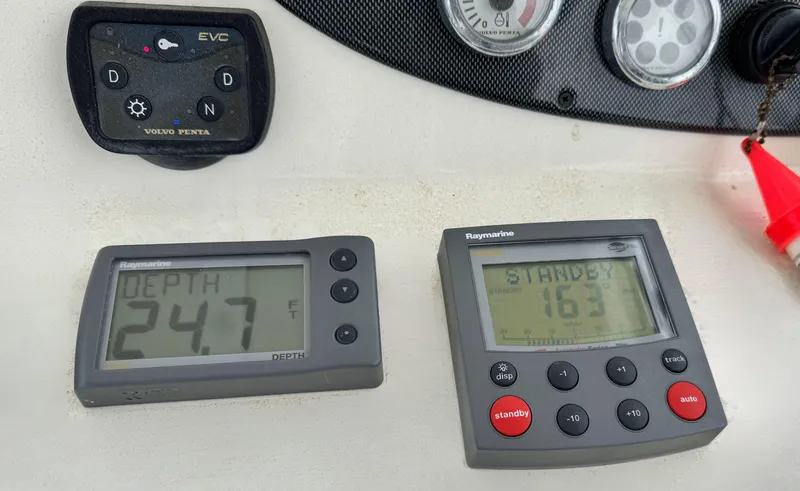 Slide: The Image of Boat control panel with depth and navigation displays, Riviera 33 Flybridge 2005. - 44