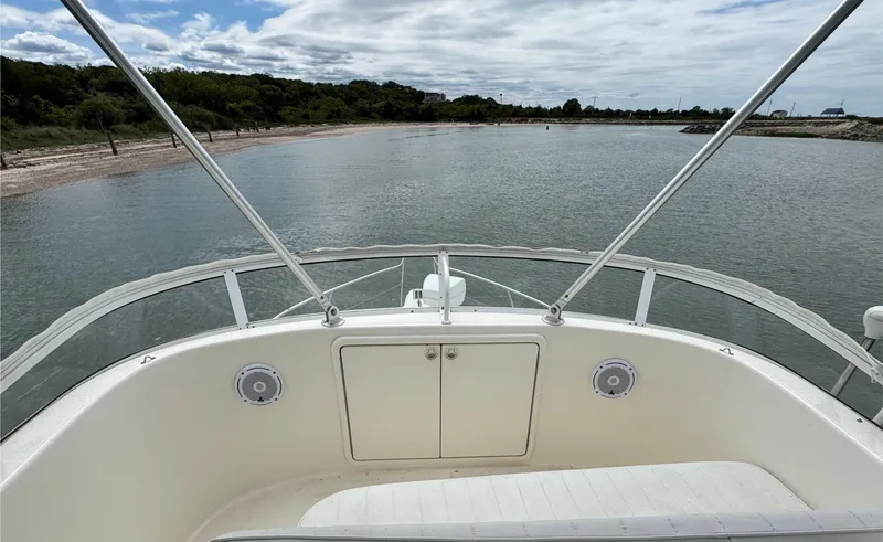 Slide: The Image of 2005 Riviera 33 Flybridge boat on calm water, view from the deck. - 45