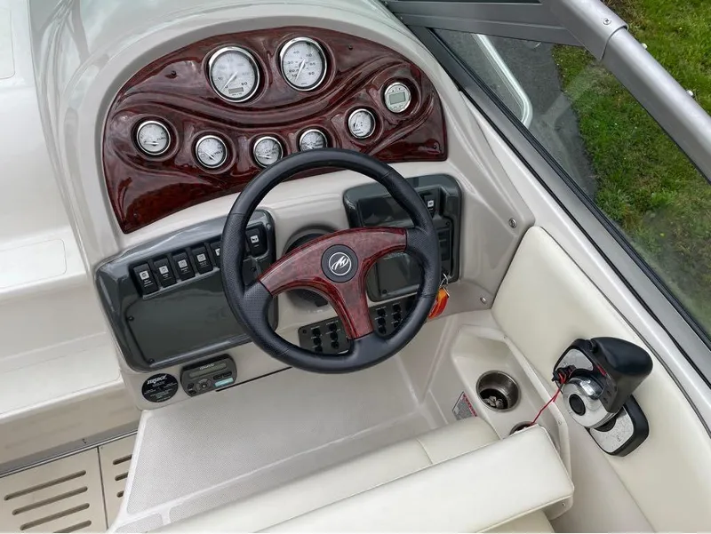 Slide: The Image of Steering console of a 2006 Monterey 250 CR boat with gauges and controls. - 10
