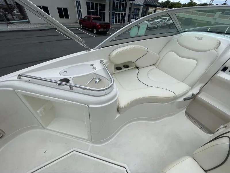 Slide: The Image of Interior of a 2006 Monterey 250 CR boat with white seating and built-in cup holders. - 16