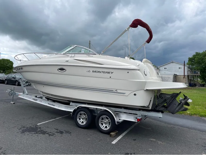 Slide: The Image of 2006 Monterey 250 CR boat on trailer under cloudy sky. - 18
