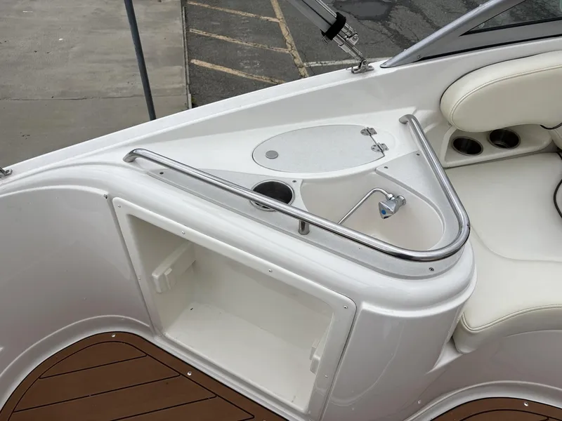 Slide: The Image of 2006 Monterey 250 CR boat interior with sink, storage, and seating area. - 24