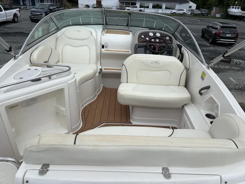 Slide: The Image of 2006 Monterey 250 CR boat interior with white seating and wood flooring. - 26