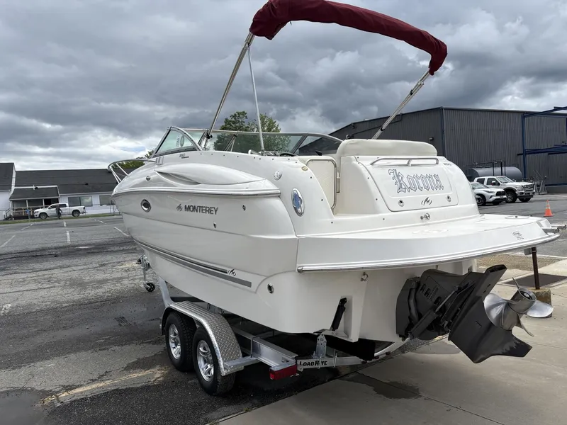 Slide: The Image of 2006 Monterey 250 CR boat on trailer, overcast sky, marina background. - 29