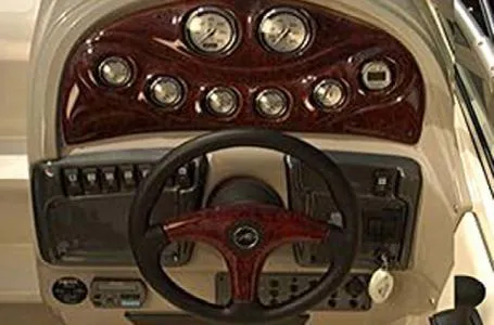 Slide: The Image of Dashboard of a 2006 Monterey 250 CR boat with gauges and steering wheel. - 3