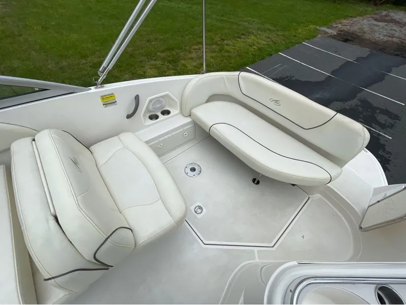 Slide: The Image of 2006 Monterey 250 CR boat interior with white seating and cup holders. - 39