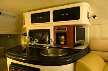 Slide: The Image of 2006 Monterey 250 CR boat interior with kitchenette, sink, and storage cabinets. - 4