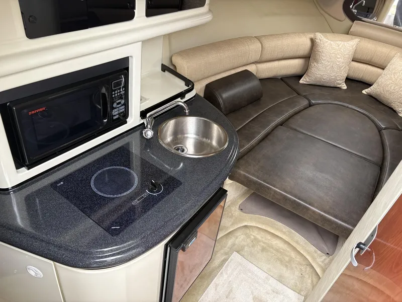 Slide: The Image of Interior of a 2006 Monterey 250 CR boat with kitchenette and seating area. - 40