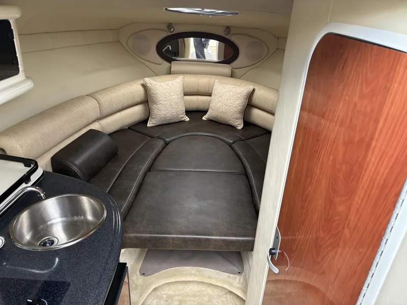 Slide: The Image of Interior of a 2006 Monterey 250 CR boat with cozy seating and kitchenette. - 41