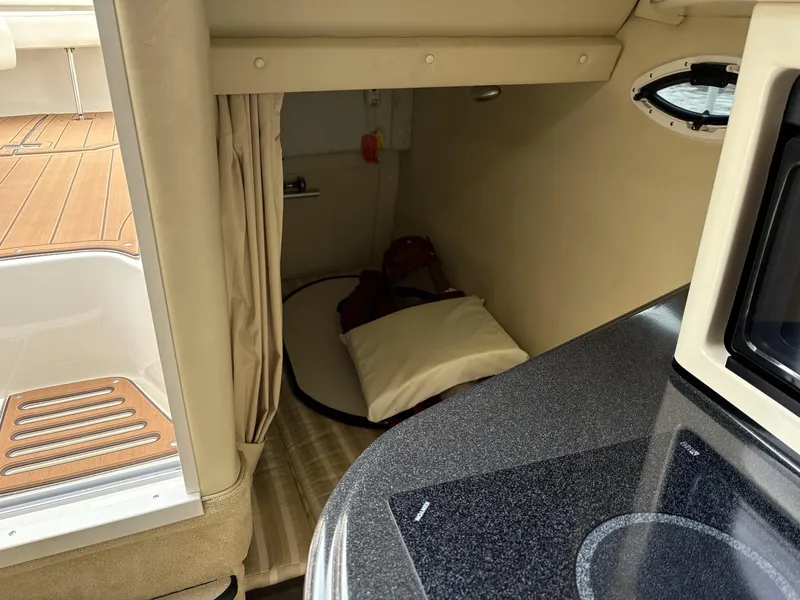 Slide: The Image of Interior cabin of a 2006 Monterey 250 CR boat with cozy sleeping area. - 42