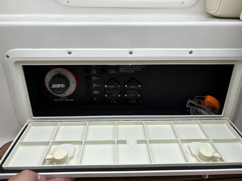 Slide: The Image of Control panel of a 2006 Monterey 250 CR boat with battery switch and storage compartments. - 45