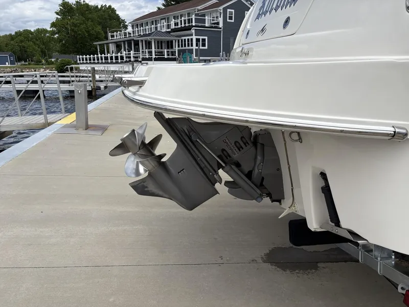 Slide: The Image of 2006 Monterey 250 CR boat docked, showing propeller and stern details. - 49