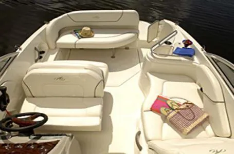 Slide: The Image of 2006 Monterey 250 CR boat interior with white seating and accessories on a sunny day. - 5