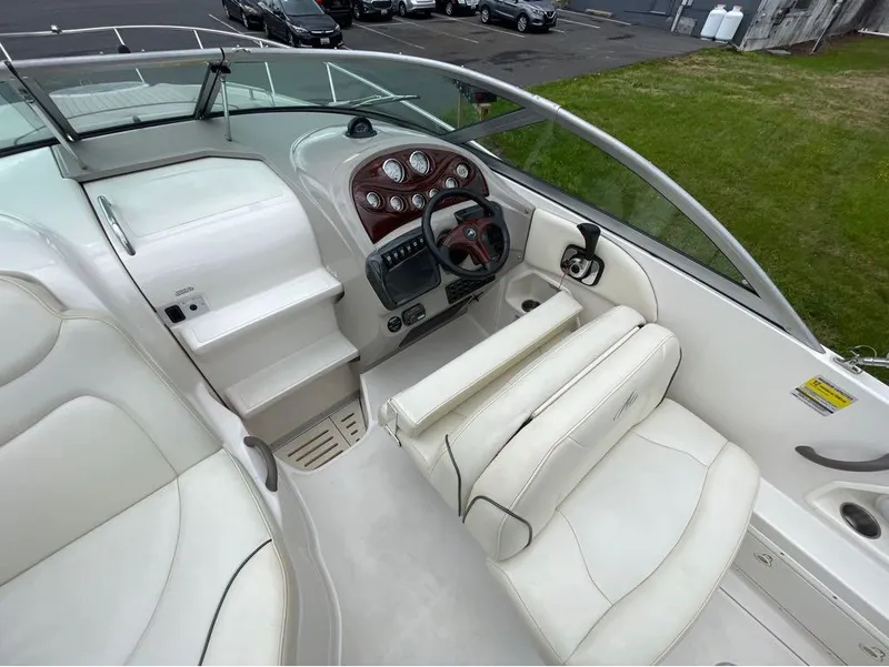 Slide: The Image of 2006 Monterey 250 CR boat interior with white seating and control panel. - 8