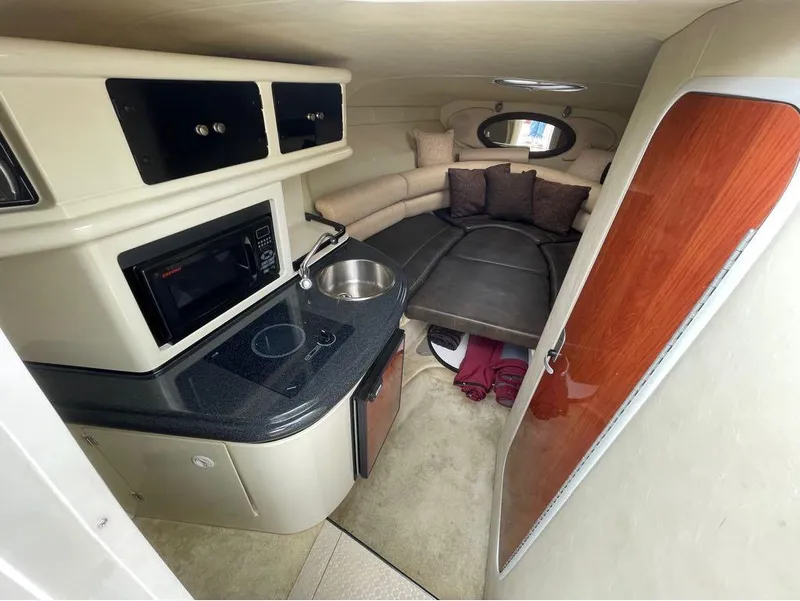 Slide: The Image of Interior of 2006 Monterey 250 CR boat with kitchenette and seating area. - 9