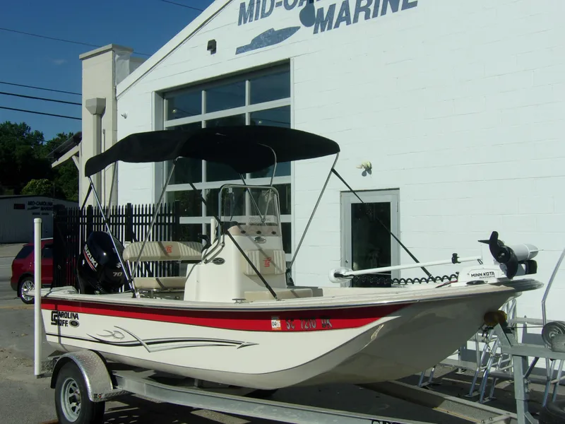 Slide: The Image of 2019 Carolina Skiff 18 JVX CC boat on trailer outside marine dealership. - 1
