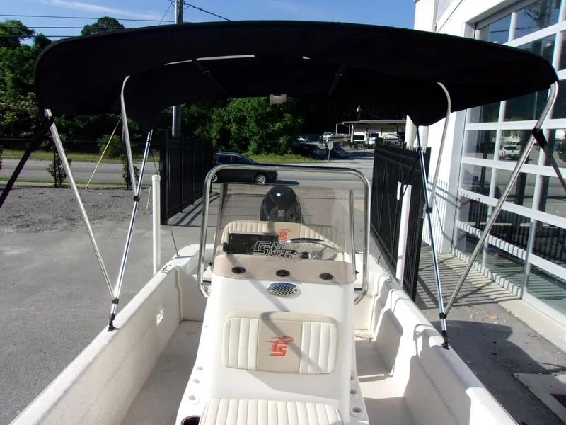 Slide: The Image of 2019 Carolina Skiff 18 JVX CC boat with canopy, parked outdoors. - 20