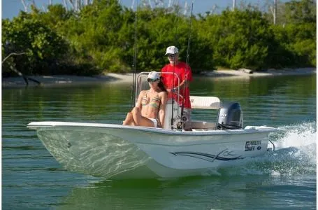 Slide: The Image of 2019 Carolina Skiff 18 JVX CC boat cruising on calm water with two passengers. - 3