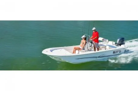 Slide: The Image of 2019 Carolina Skiff 18 JVX CC boat cruising on water with two passengers. - 5