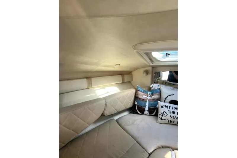 Slide: The Image of Interior cabin of 2006 Sea Ray 240 Sundancer with cushions and pillows. - 11