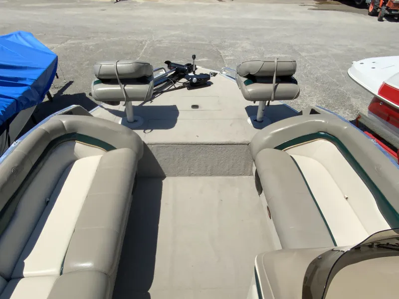 Slide: The Image of 1998 Sun Tracker Party Deck 21 boat interior with seating and steering area. - 3