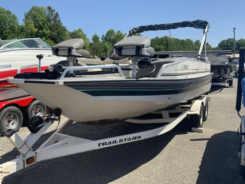 Slide: The Image of 1998 Sun Tracker Party Deck 21 boat on a trailer, parked outdoors. - 5