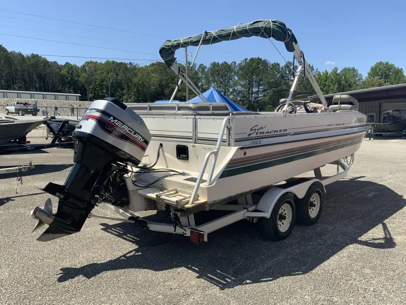 Slide: The Image of 1998 Sun Tracker Party Deck 21 boat on trailer with Mercury outboard motor. - 6