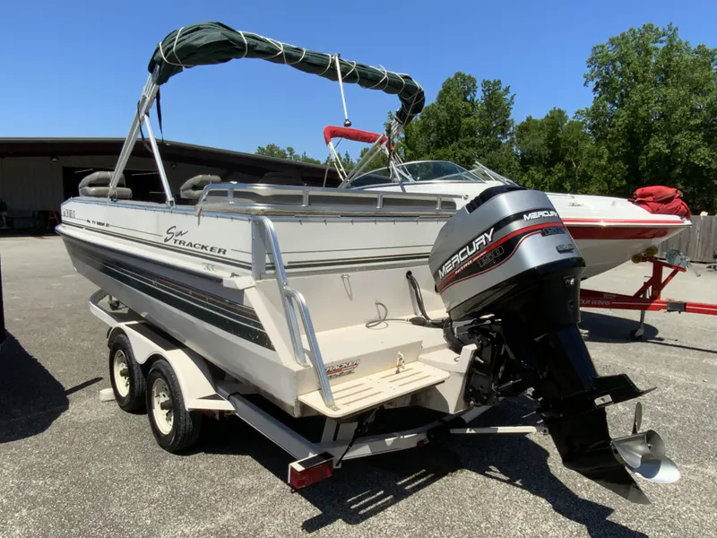 Slide: The Image of 1998 Sun Tracker Party Deck 21 boat with Mercury outboard motor on trailer. - 7