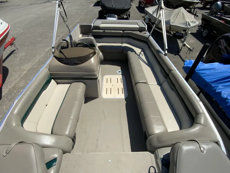 Slide: The Image of 1998 Sun Tracker Party Deck 21 boat interior with spacious seating and steering console. - 8