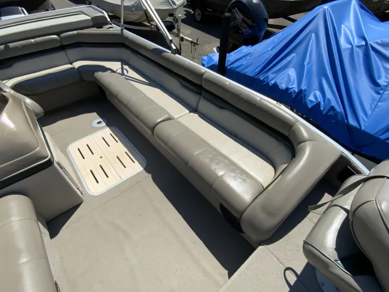 Slide: The Image of 1998 Sun Tracker Party Deck 21 boat interior with gray seating and carpeted floor. - 9